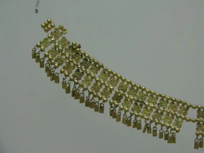 Gold necklace with spirals forming a cross